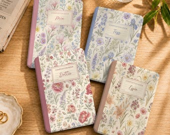 May include: Four composition books with floral patterns and personalised names Mia, Tess, Dottie, and Effie printed on rectangular labels. Each notebook features a coloured spine and a cover decorated with various botanical illustrations in soft pastel tones.