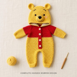 May include: A yellow and red crocheted hooded romper featuring a bear face on the hood with ears, black eyes, and a black nose. The garment has a front button closure with four light-colored buttons. A ball of yellow yarn and a crochet hook are present.