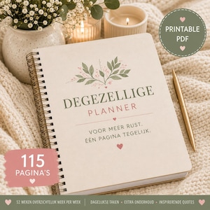 May include: A spiral-bound planner with a cream cover featuring green leaf illustrations, small pink hearts, and the text DEGEZELLIGE PLANNER, VOOR MEER RUST. ÉÉN PAGINA TEGELIJK. A gold pen rests beside the planner, which includes 115 PAGINA'S.
