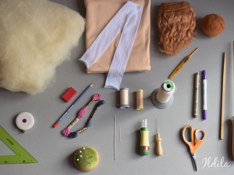 May include: A collection of craft supplies for making a doll, including yarn, fabric, felt, needles, thread, and a crochet hook.