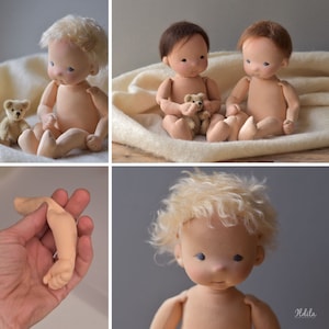 May include: Three handmade cloth dolls with blonde and brown hair. The dolls are sitting on a white blanket. One doll is holding a small teddy bear.