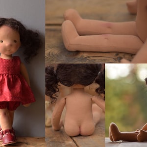 May include: A handmade doll with brown hair and a red dress. The doll is sitting on a wooden surface.