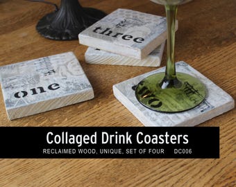 May include: A set of four collaged drink coasters made from reclaimed wood. Each square coaster has a unique design with the numbers "one", "two", and "three" in black. A green-stemmed wine glass rests on one.