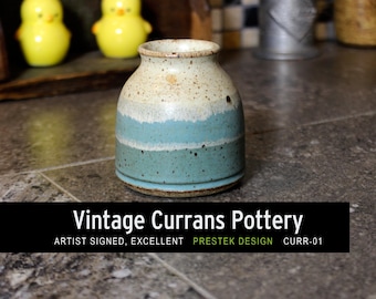 May include: A small ceramic vase featuring a speckled cream top, a light blue middle band, and a darker teal base. The text on the image reads: Vintage Currans Pottery, ARTIST SIGNED, EXCELLENT, PRESTEK DESIGN, CURR-01.