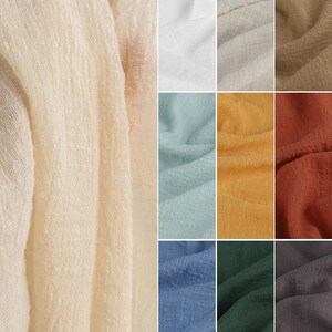 May include: A collection of textured fabric swatches in various colors including cream, white, light gray, beige, light blue, yellow, terracotta, blue, dark green, and charcoal gray. Each piece of fabric features a crinkled, semi-sheer appearance.