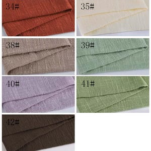 May include: A collection of seven fabric swatches featuring a textured, woven appearance. The colors include rust, cream, beige, light green, lavender, olive green, and dark brown. Each swatch is labeled with a number from 34# to 42#.