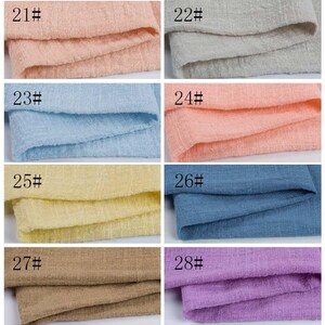 May include: A grid of eight fabric swatches with a textured, woven appearance. Each swatch is labeled with a number from 21# to 28#. The colors include light pink, light gray, light blue, peach, pale yellow, medium blue, tan, and light purple.