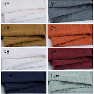 May include: A grid of eight fabric swatches featuring a textured, woven appearance. The colors include white, dark gray, mustard yellow, burnt orange, another white, deep burgundy, navy blue, and light sage green, each labeled with a number.