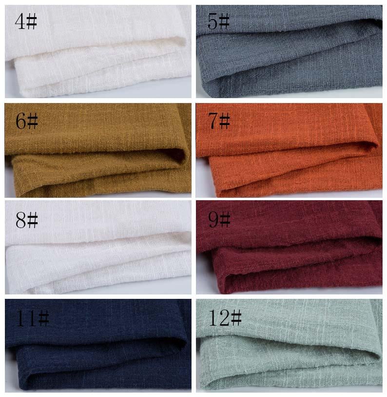 May include: A grid of eight fabric swatches featuring a textured, woven appearance. The colors include white, dark gray, mustard yellow, burnt orange, another white, deep burgundy, navy blue, and light sage green, each labeled with a number.
