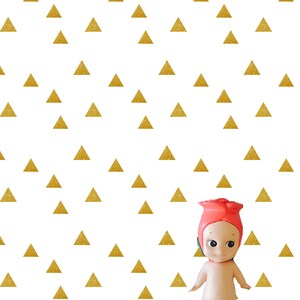 May include: A small, nude-colored doll with a red rose head and a green stem. The doll is standing on a white background with a pattern of gold glitter triangles.