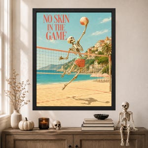 May include: A framed wall art print featuring a skeleton playing beach volleyball with the text NO SKIN IN THE GAME. The scene shows a skeleton jumping to hit a volleyball over a net on a sandy beach with a coastal town in the background.