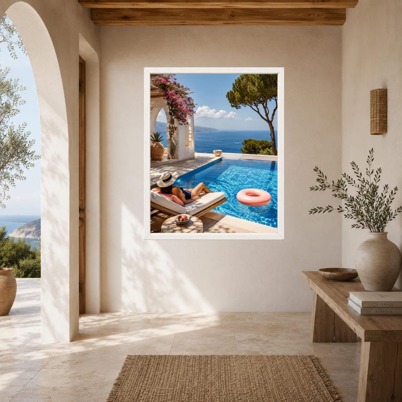 May include: A framed wall art print depicting a sunny Mediterranean terrace with a swimming pool, a person lounging on a sunbed, a pink inflatable ring floating in the water, vibrant pink bougainvillea flowers, and a distant blue sea view.
