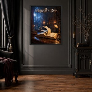 May include: A framed wall art print titled The Library at Dusk, depicting an open book on a wooden desk inside a dark, multi-story library. The scene features tall bookshelves, a glowing desk lamp, and a large window showing a moonlit night sky.