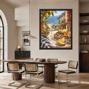 May include: A framed wall art print depicting a Mediterranean coastal scene with a martini, a tin of sardines, lemon wedges, and olives on a marble table. The artwork features a vibrant blue sea, rocky cliffs, and lush greenery in the background.
