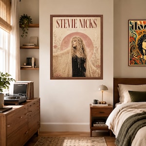 May include: A framed wall poster featuring a portrait of Stevie Nicks with the text STEVIE NICKS and BELLA DONNA DREAMS. The artwork displays a person with long blonde hair wearing a lace shawl against a large pink moon and floral background.