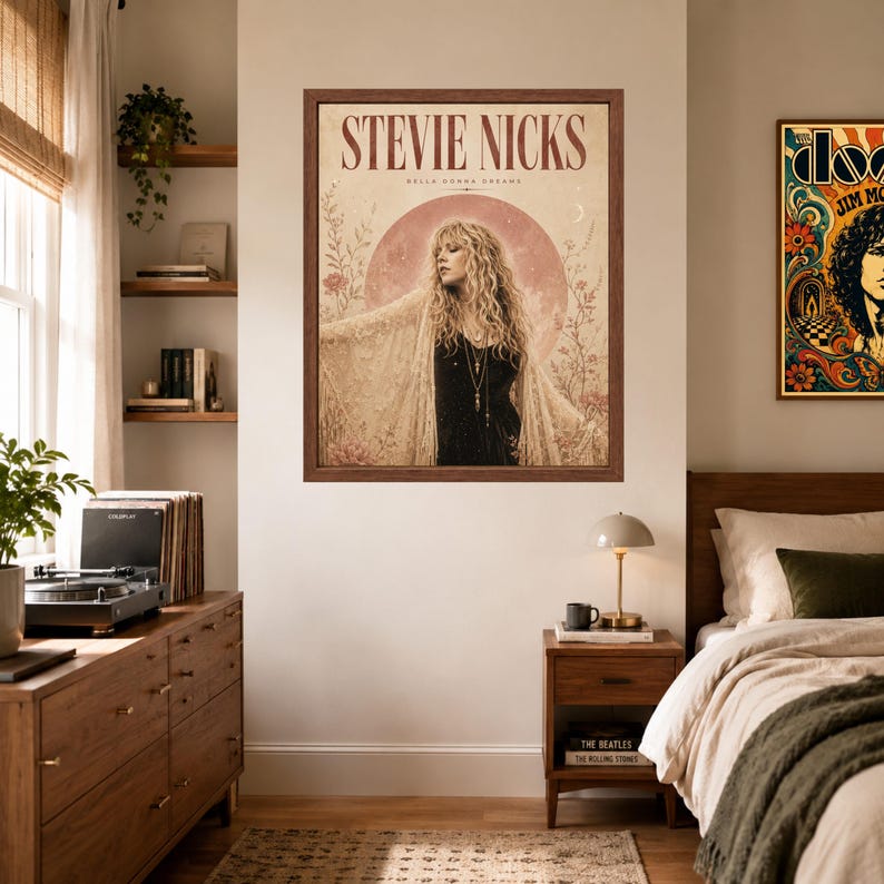 May include: A framed wall poster featuring a portrait of Stevie Nicks with the text STEVIE NICKS and BELLA DONNA DREAMS. The artwork displays a person with long blonde hair wearing a lace shawl against a large pink moon and floral background.