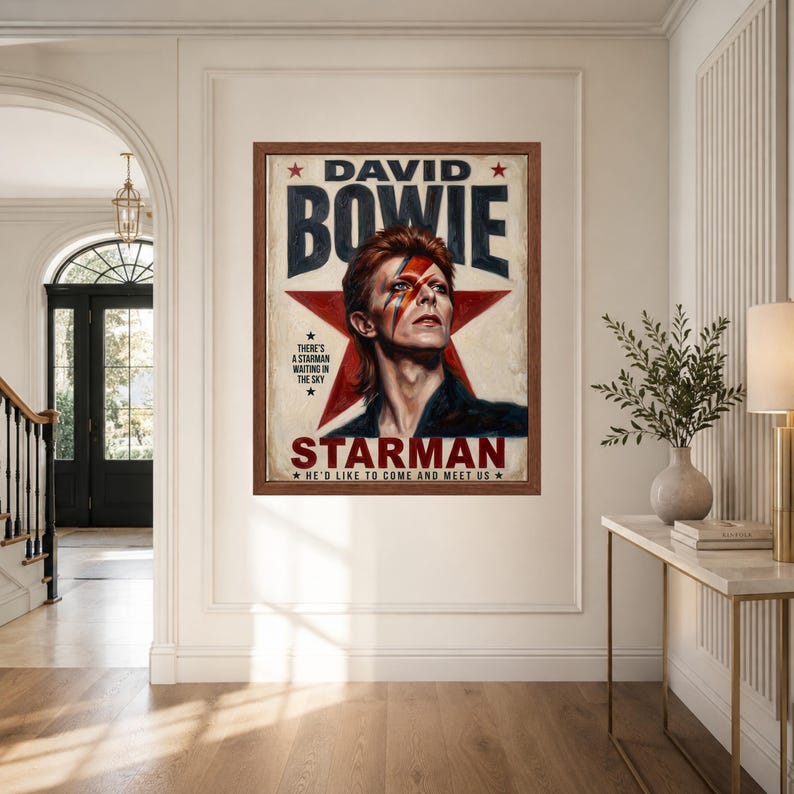 May include: A framed rectangular poster featuring a portrait of David Bowie with a red lightning bolt across his face. The background includes a large red star and the text DAVID BOWIE STARMAN, THERE'S A STARMAN WAITING IN THE SKY, HE'D LIKE TO COME AND MEET US.