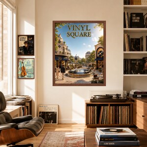 May include: A framed wall art print titled VINYL SQUARE featuring a European-style plaza with a central fountain, surrounded by buildings and trees. The artwork is displayed on a wall above a wooden record player console and vinyl record storage.