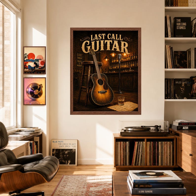 May include: A framed wall art print titled LAST CALL GUITAR featuring an acoustic guitar leaning against a wooden stool in a dimly lit bar setting with a microphone stand, a glass of whiskey, and shelves of bottles in the background.