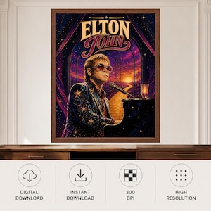 May include: A framed wall art print featuring Elton John wearing star-patterned clothing and sunglasses, seated at a piano. The background displays a yellow brick road leading toward a sunset under a starry sky, with the text ELTON JOHN at the top.