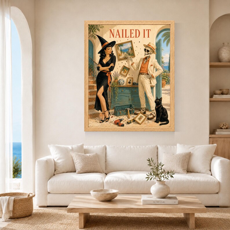 May include: A framed wall art print titled NAILED IT featuring a witch in a black dress and a skeleton in a beige suit standing in a room with tools, a toolbox, and a black cat. The scene depicts a home renovation project with framed pictures.