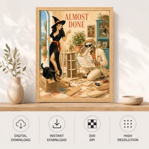 May include: A framed wall art print titled ALMOST DONE featuring a vintage-style illustration of a witch in a black dress and a skeleton in a suit assembling furniture. A black cat sits in a cardboard box nearby, and the scene includes tools, wooden boards, and a set of instructions on a tiled floor.