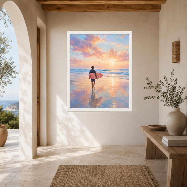 May include: A framed wall art print depicting a surfer walking along a wet sandy beach at sunset, carrying a pink surfboard. The sky is filled with soft pink and orange clouds, and the scene reflects clearly on the water-covered sand surface.