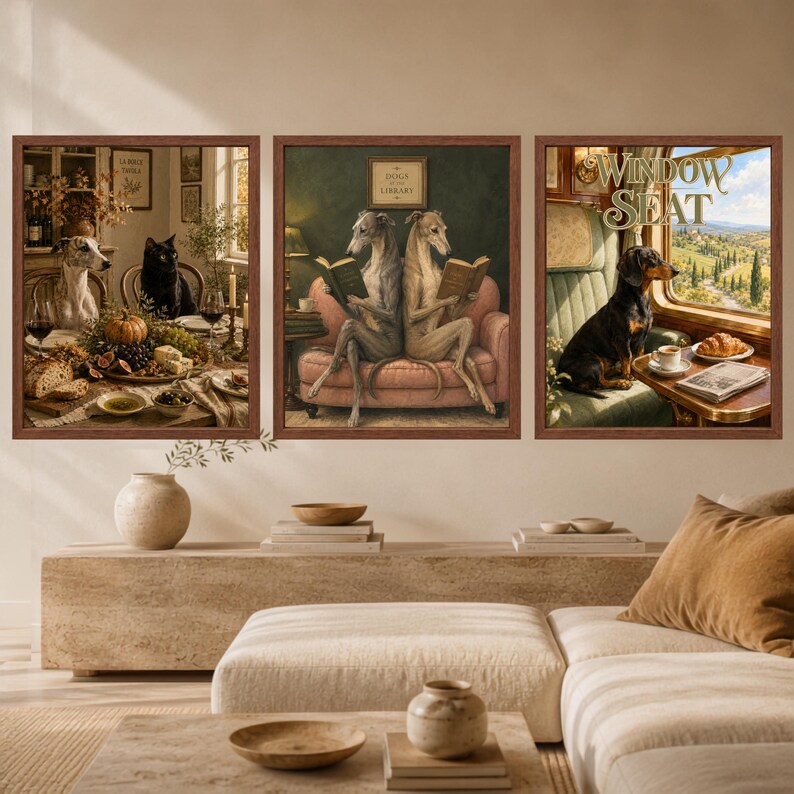 May include: A set of three framed wall art prints featuring anthropomorphic dogs. The left print shows a greyhound and black cat at a table, the center print shows two greyhounds reading on a sofa, and the right print shows a dachshund by a train window.
