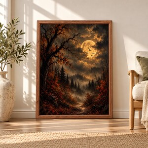 Framed dark autumn forest wall art showing a glowing full moon, flying bats, misty pine trees and an orange leaf-covered path beneath dramatic storm clouds.