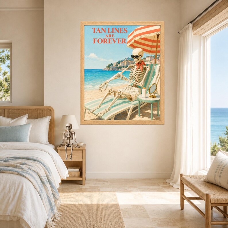May include: A framed wall art print featuring a skeleton wearing sunglasses and a red neckerchief, lounging on a beach chair under a red and white striped umbrella. The text TAN LINES ARE FOREVER is printed in red above the skeleton.