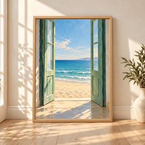 Framed Mediterranean coastal wall art showing open sage green doors facing a sandy beach, turquoise sea and clear blue sky in warm sunlight.