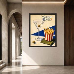May include: A framed wall art print featuring a martini glass with an olive, a red and white striped container of french fries, and a loose olive on a cream and blue background. The text MARTINI & FRIES is printed in a stylized font at the top.
