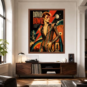 May include: A framed wall poster featuring a stylized illustration of David Bowie in a striped jumpsuit. The text reads David Bowie, Starman, Rebel, and Icon. The background includes a large red lightning bolt, a moon, and a colorful sunburst design.