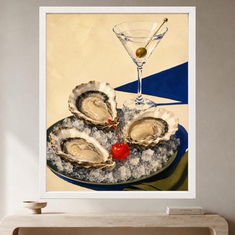 May include: A framed painting depicting three raw oysters resting on a bed of crushed ice on a dark plate. A martini glass containing a single green olive on a pick stands behind the oysters, and a bright red cherry sits among the ice.