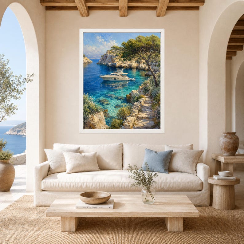 May include: A framed landscape painting depicting a white yacht floating on clear blue water in a rocky cove. The scene includes a stone path leading along the cliffside, lush green trees, and a bright sky with soft clouds above the coastal inlet.