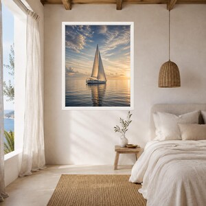 May include: A framed wall art print featuring a white sailboat gliding across calm water during a golden sunset. The sky is filled with soft, wispy clouds illuminated by warm light, creating a serene reflection on the surface of the ocean.