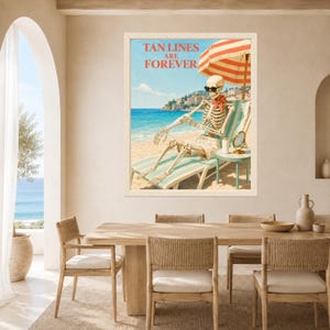 May include: A framed wall art print featuring a skeleton wearing sunglasses and a red neckerchief, lounging on a beach chair under a red and white striped umbrella. The text TAN LINES ARE FOREVER is printed in red at the top of the coastal scene.