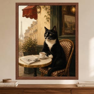 May include: A framed wall art print depicting a black and white cat sitting on a bistro chair at a small round table. On the table sits a white coffee cup and a newspaper. The background shows a Parisian street scene with the Eiffel Tower.