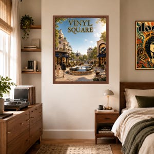 May include: A framed wall art print titled VINYL SQUARE featuring a sunny European-style plaza with a central fountain, surrounding buildings, and people walking. The scene includes a record player and vinyl records integrated into the architecture.