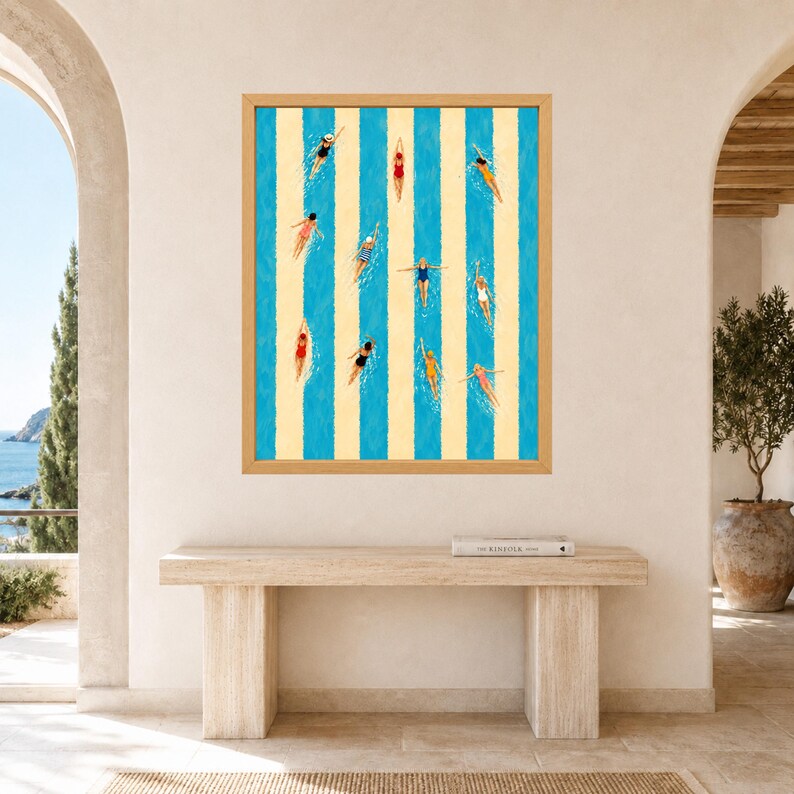 May include: A framed rectangular wall art print featuring an overhead view of multiple swimmers in a pool with alternating vertical blue and cream stripes. The swimmers wear various colored swimsuits and are positioned across the striped lanes.