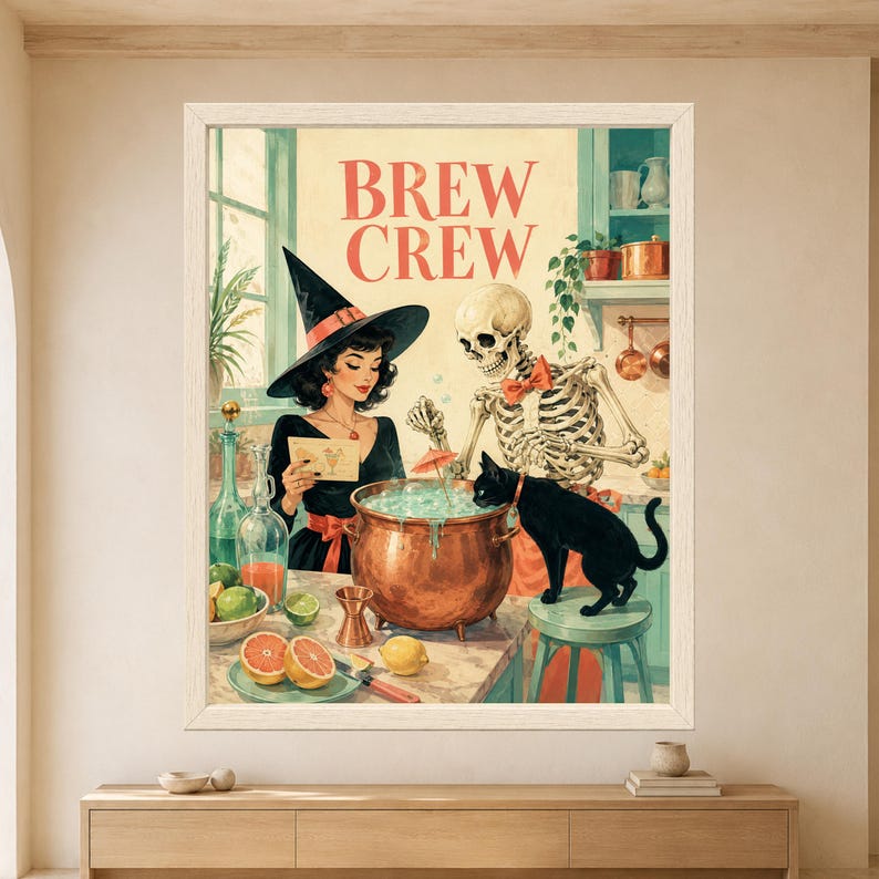 Framed Brew Crew Halloween wall art featuring a stylish witch, skeleton and black cat gathered around a bubbling copper cauldron with citrus, bottles and cocktail tools in a retro kitchen.