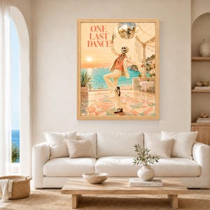 May include: A framed wall art print titled ONE LAST DANCE featuring a skeleton wearing a cream suit and orange shirt dancing on a terrace. Above the skeleton hangs a disco ball, with a coastal ocean view, sunset, and a table in the background.