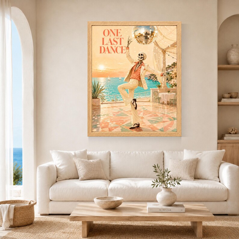 May include: A framed wall art print titled ONE LAST DANCE featuring a skeleton wearing a cream suit and orange shirt dancing on a terrace. Above the skeleton hangs a disco ball, with a coastal ocean view, sunset, and a table in the background.