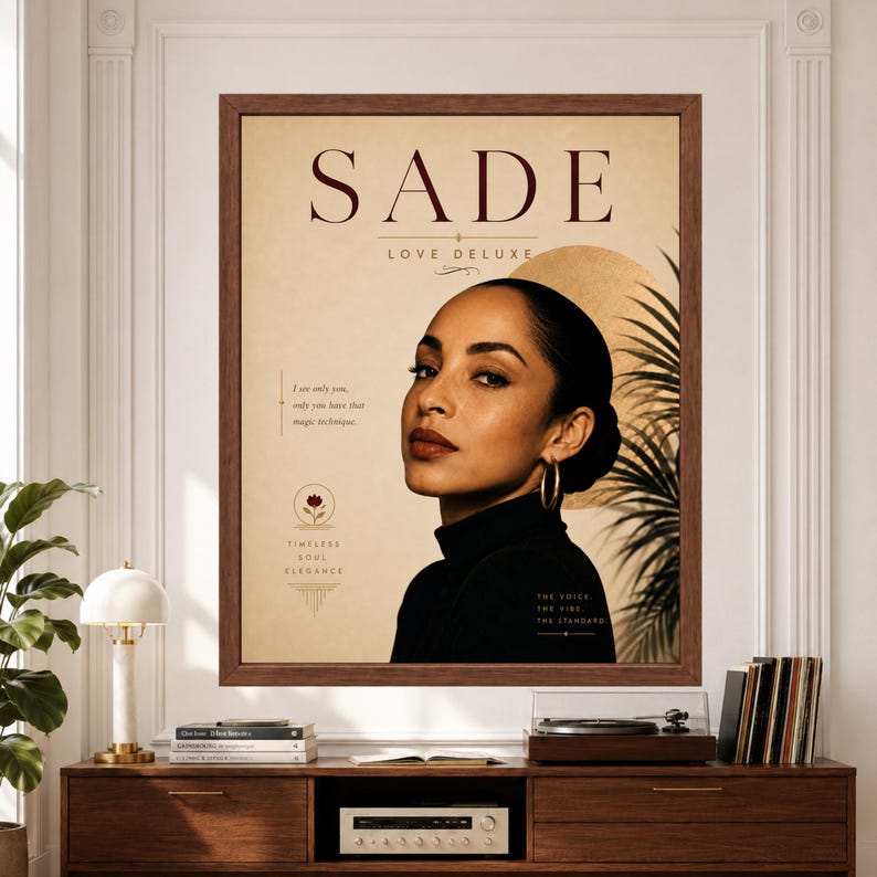 Framed Sade wall art featuring an elegant Love Deluxe inspired portrait in warm cream, black and muted gold with minimalist typography, subtle botanical details and refined editorial styling above a record player console.