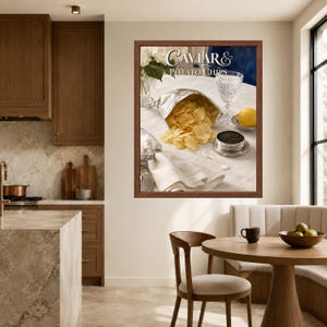May include: A framed wall art print featuring a silver bag of golden potato chips, a small bowl of black caviar, a crystal glass, a lemon, and a white napkin. The text Caviar & Potato Chips is printed in a decorative font at the top of the image.