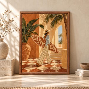 Framed coastal wall art showing a woman carrying a patterned surfboard through a warm Mediterranean archway with palm trees, terracotta walls and an ocean view.