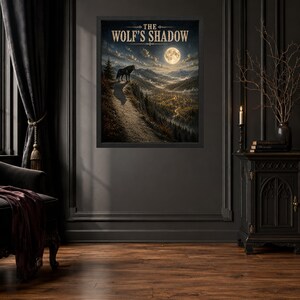 May include: A framed wall art print titled THE WOLF'S SHADOW, featuring a dark landscape with a wolf standing on a cliff edge under a full moon, overlooking a forested valley with a winding path, all rendered in deep earth tones and cool night blues.