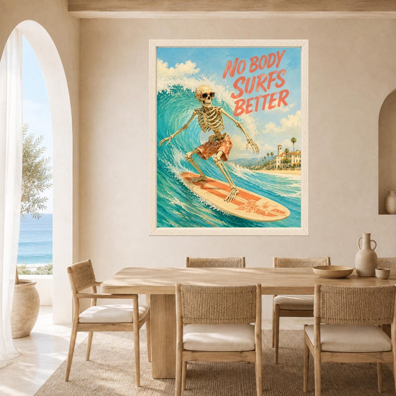 May include: A framed wall art print featuring a skeleton wearing sunglasses and orange patterned shorts, surfing on a large blue wave. The text NO BODY SURFS BETTER is printed in orange in the upper right corner, with a coastal scene in the background.