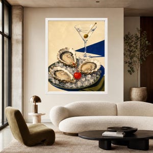 May include: A framed wall art print featuring a martini glass with a single olive, positioned above a dark plate holding three raw oysters nestled on a bed of crushed ice, accented by a bright red cherry, set against a cream and blue background.