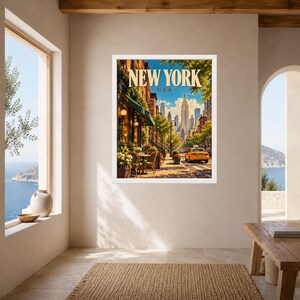May include: A framed wall art print featuring a New York City street scene with the text NEW YORK USA at the top. The image displays a sidewalk cafe with tables and chairs, lush green trees, a yellow taxi cab, and skyscrapers in the distance.